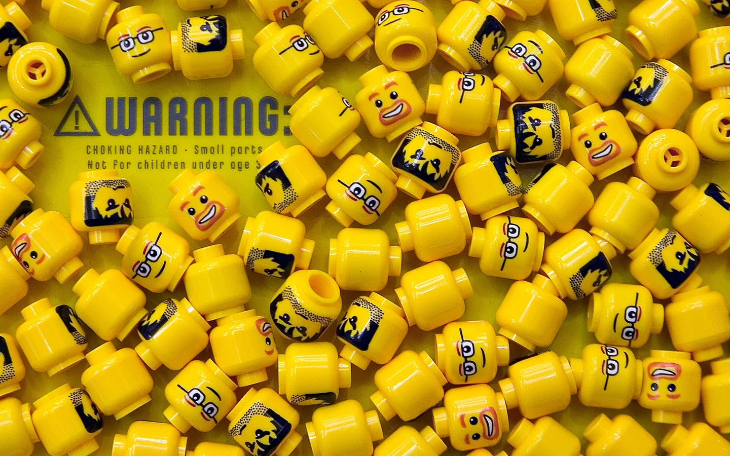 Yellow brick-compatible minifigure heads for custom figure collections